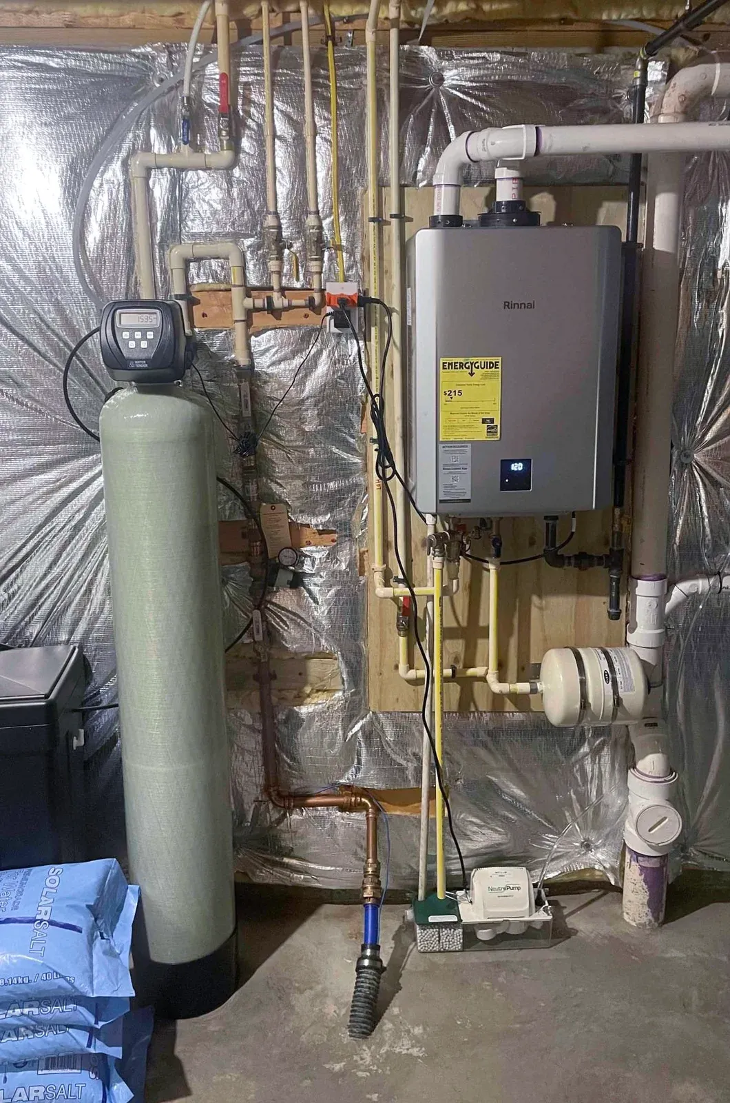 Water softener beside a Rinnai tankless water heater installed by Mallick Plumbing & Heating
